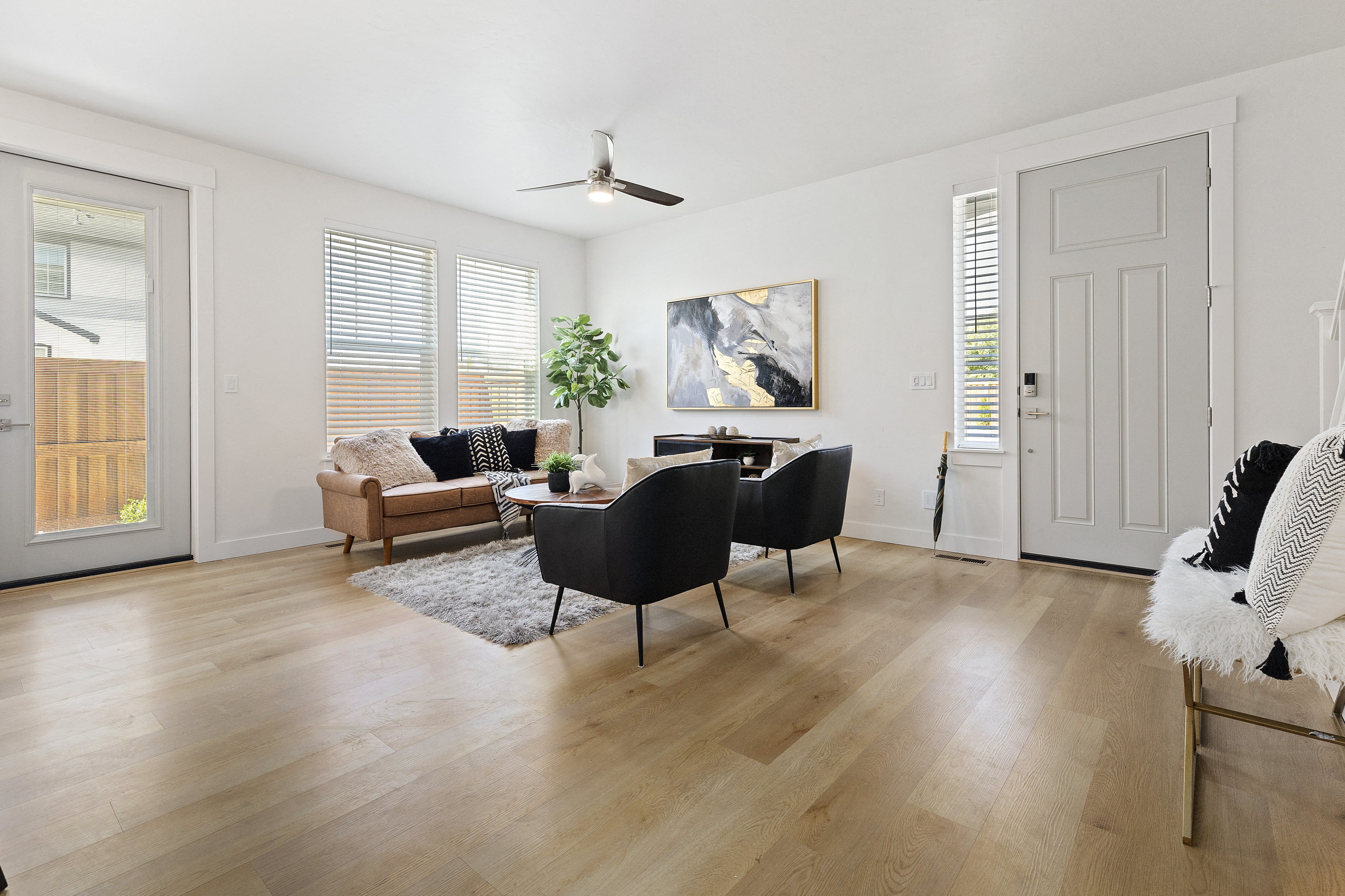 a living room with hardwood floors and white walls at Alante Homes at Lake Hazel, Idaho